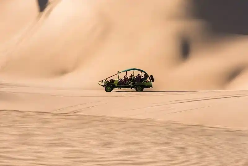 Thrilling dune buggy adventure in the Dubai desert with powerful off-road vehicles, stunning sand dune landscapes, and an unforgettable outdoor experience.