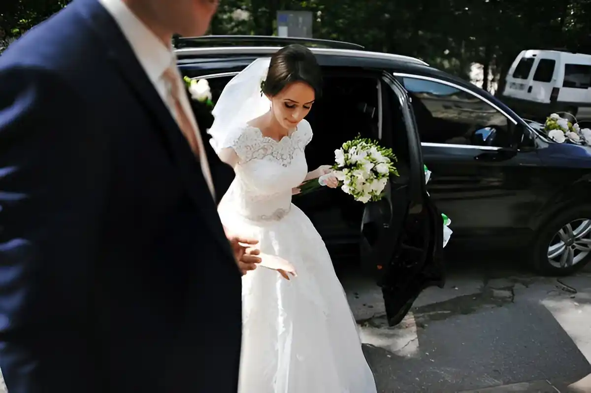 Elegant wedding car with a chauffeur, decorated for a special event, parked at a luxury venue in Dubai