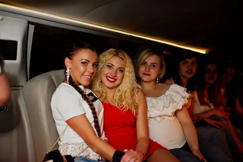 Girls having fun while sitting inside the luxurious limousin at Dubai