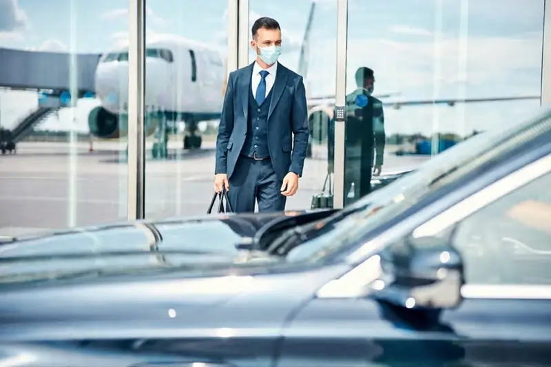 Chauffeur meeting passenger at Dubai Airport Transfers arrivals for hotel transfer